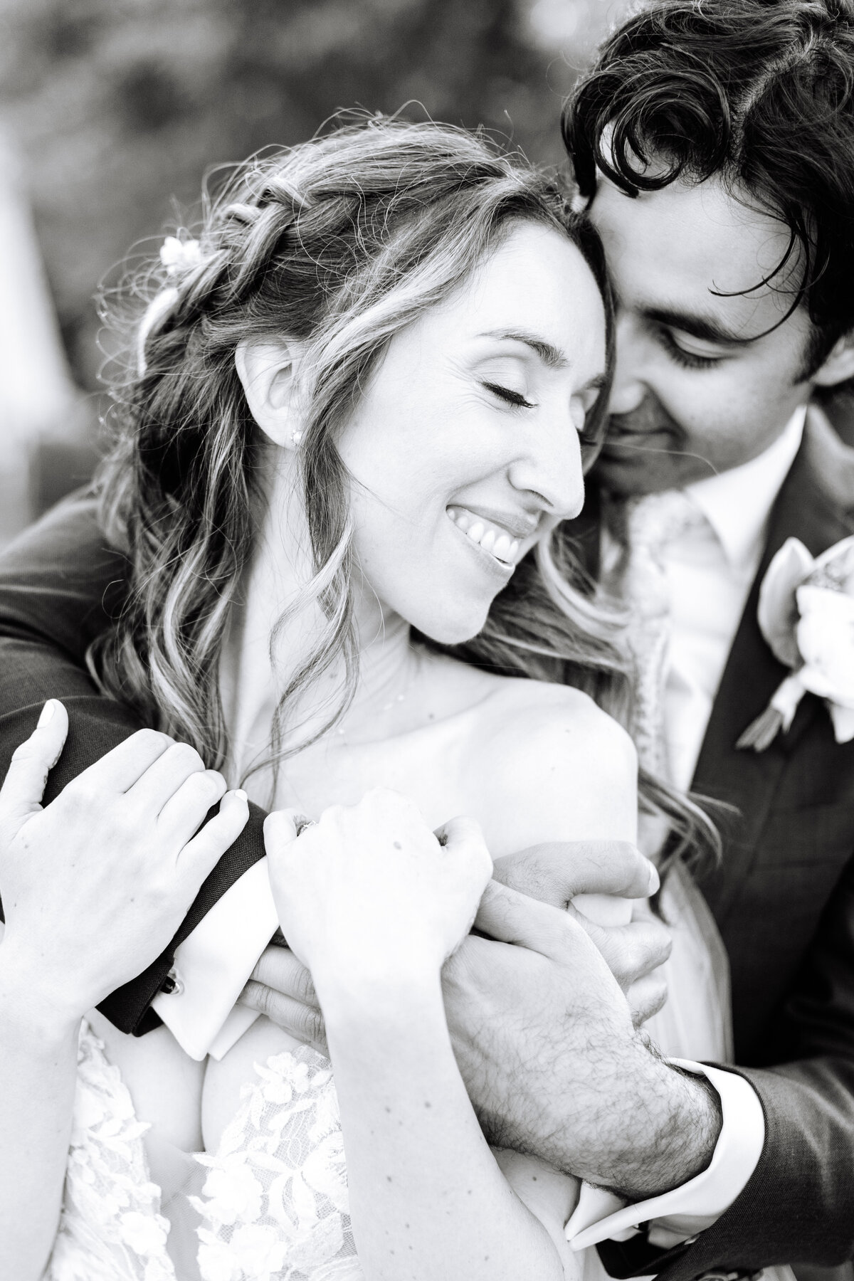 black and white close up image of sonoma county bride and groom smiling and embracing.