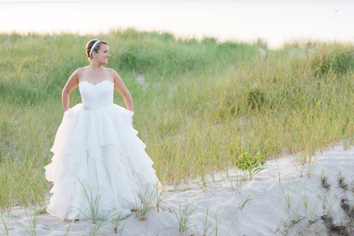 bride walking on the beach from wedding at Pavilion at Sunken Meadow