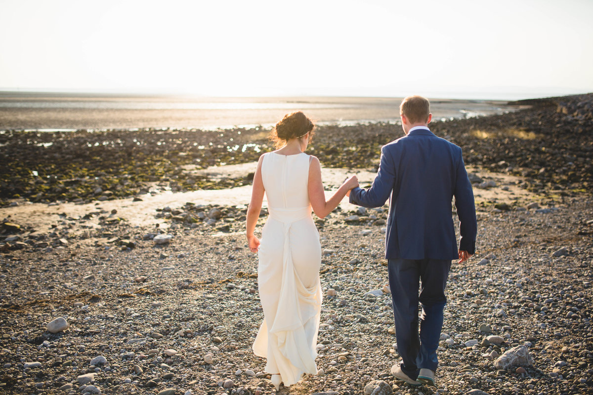 bride groom walking beach sunset