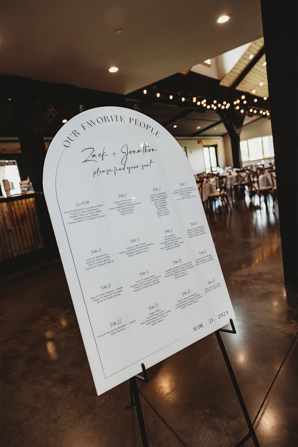 Arch acrylic seating chart for sage green mountain wedding at Camelot Ranch.