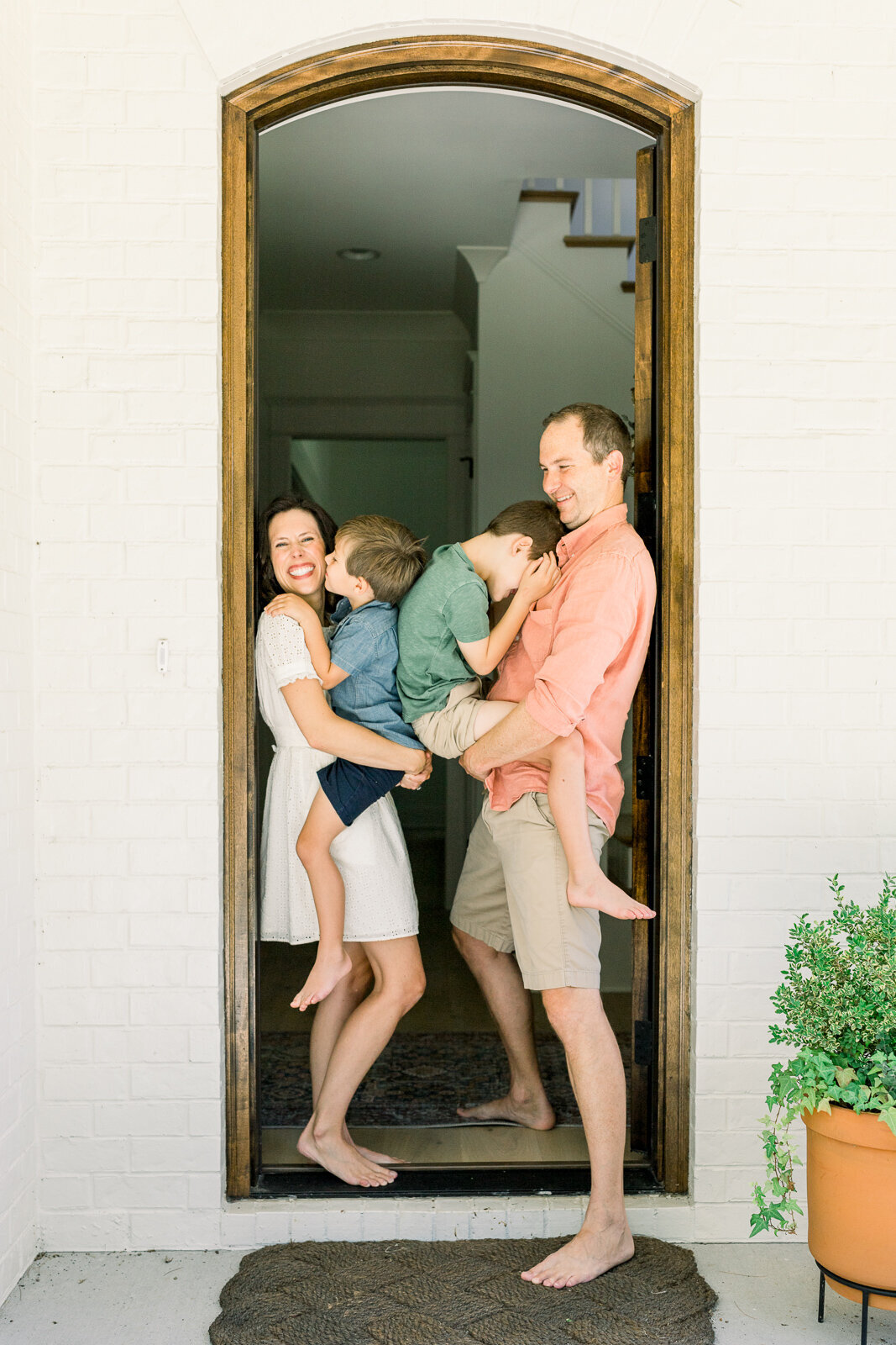 Family snuggling on front porch