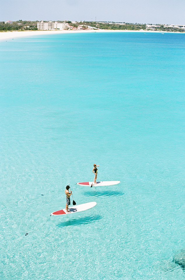 couple stand up paddleboarding at malliouhana