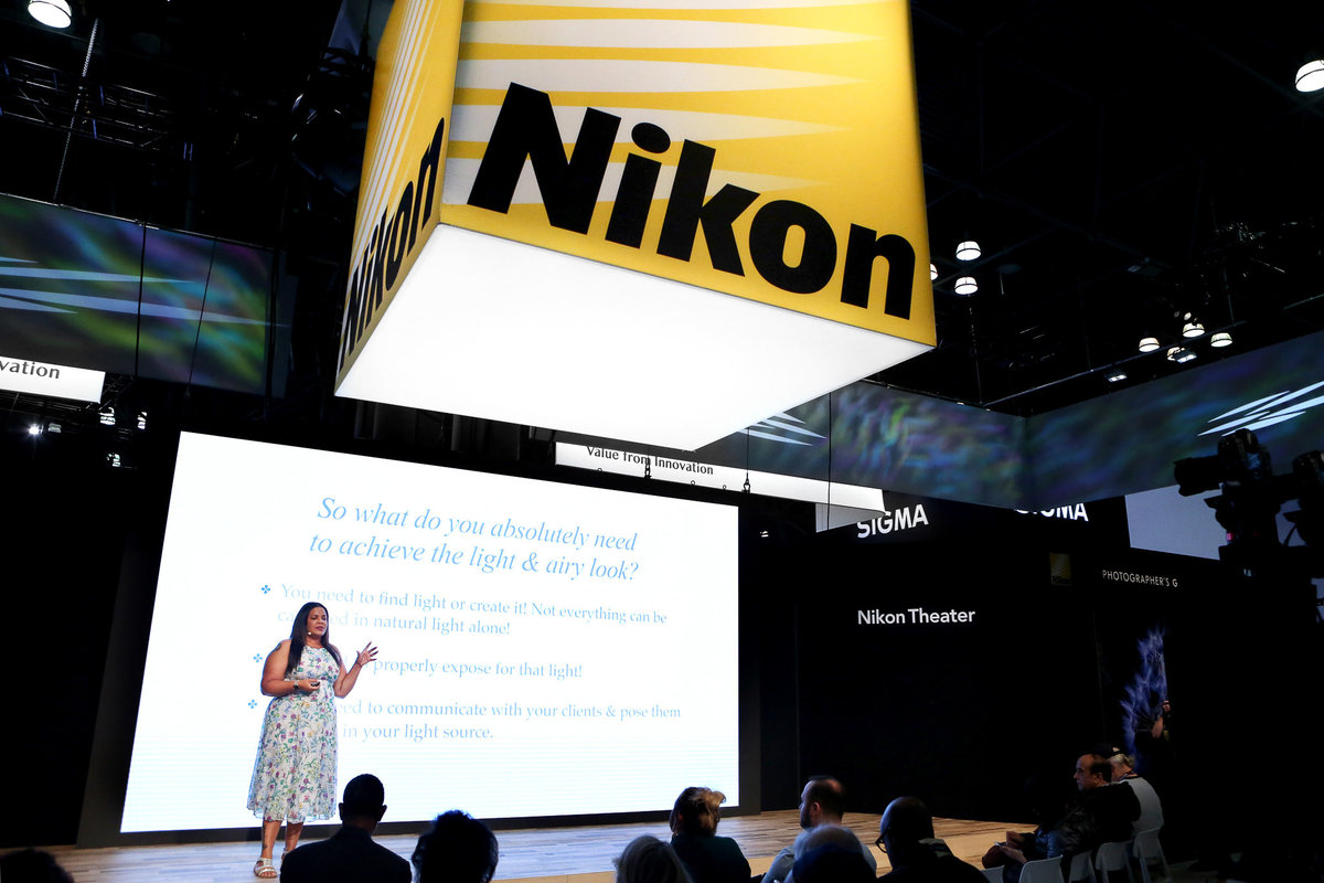 Photographer Kiamarie Stone on stage speaking at photography conference for Nikon