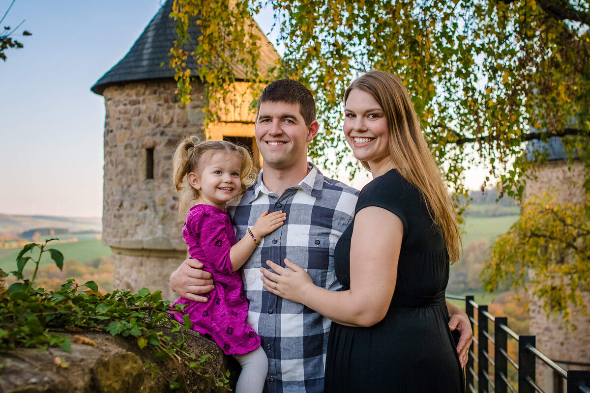 A picture of me with my husband and my daughter at a castle in Germany.