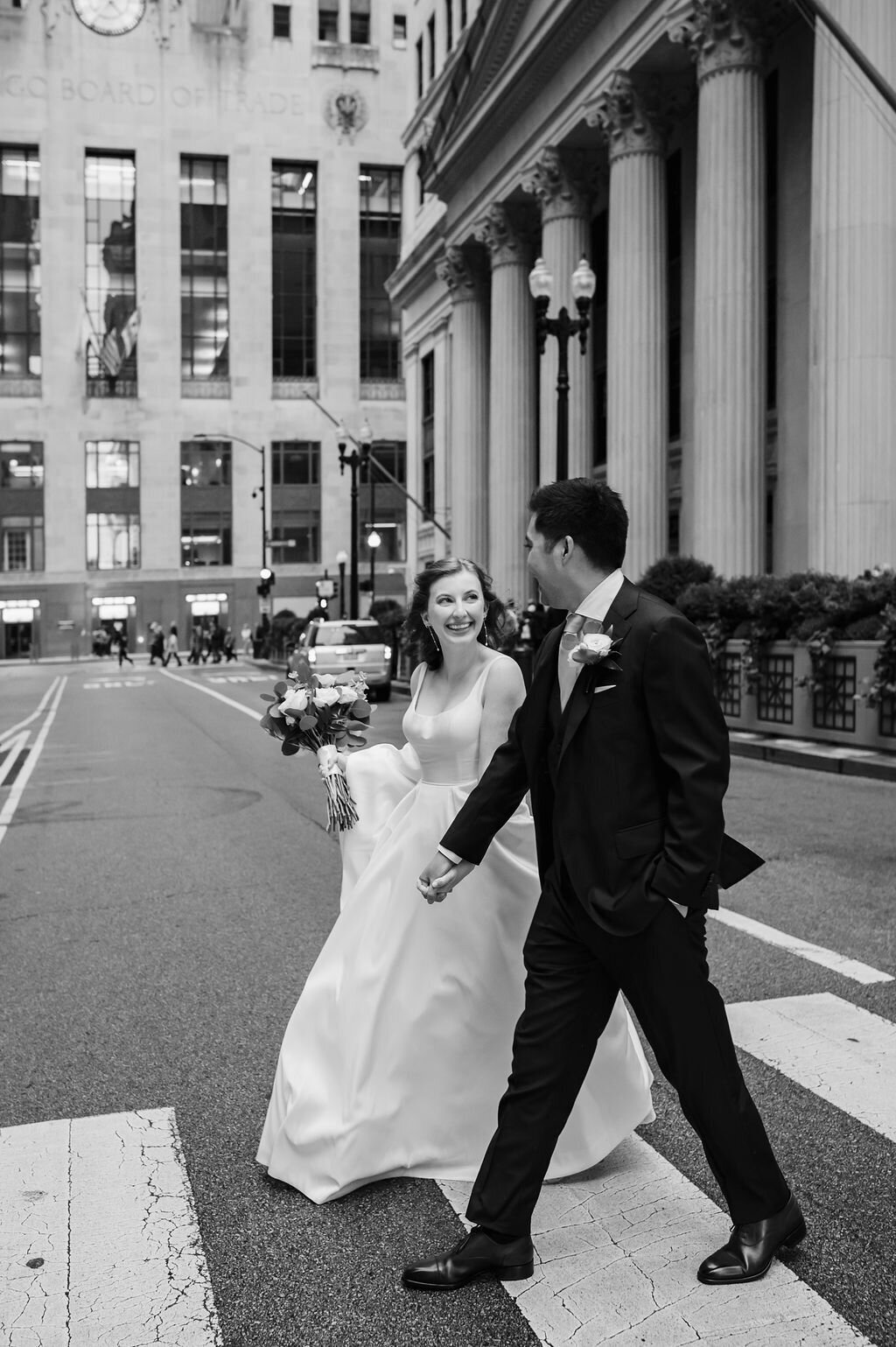 Bride and groom walk across street in Chicago, IL
