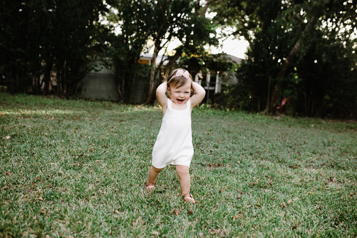 Child running through lawn at Austin family photo session