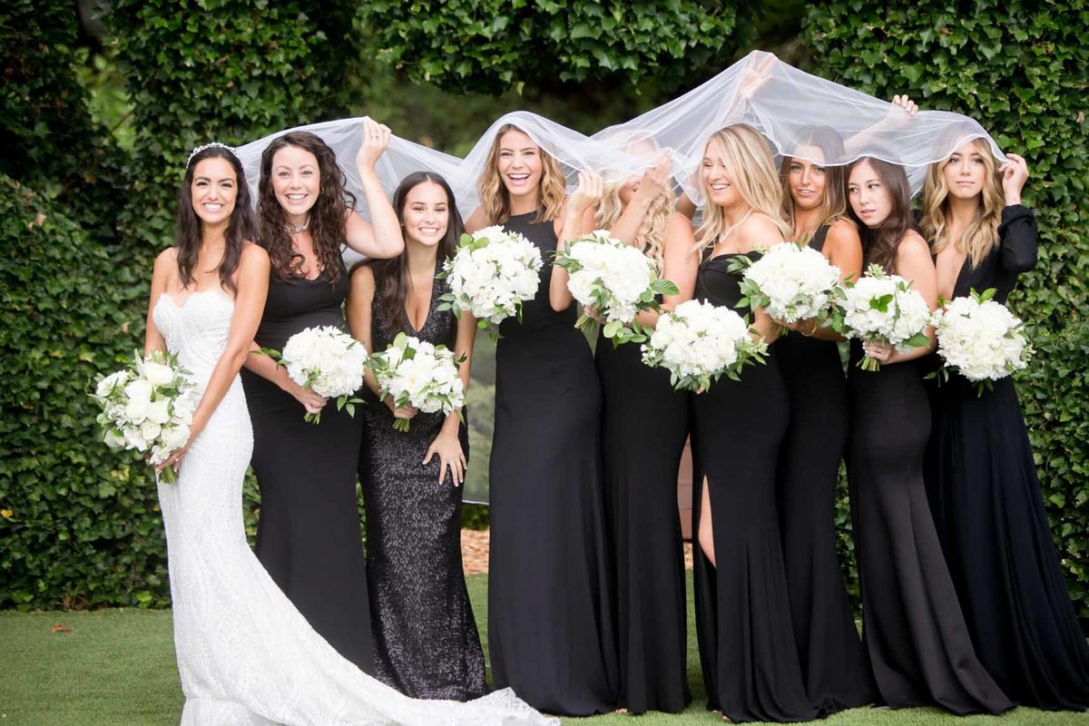 Bride and wedding party with white bouquets and black dresses