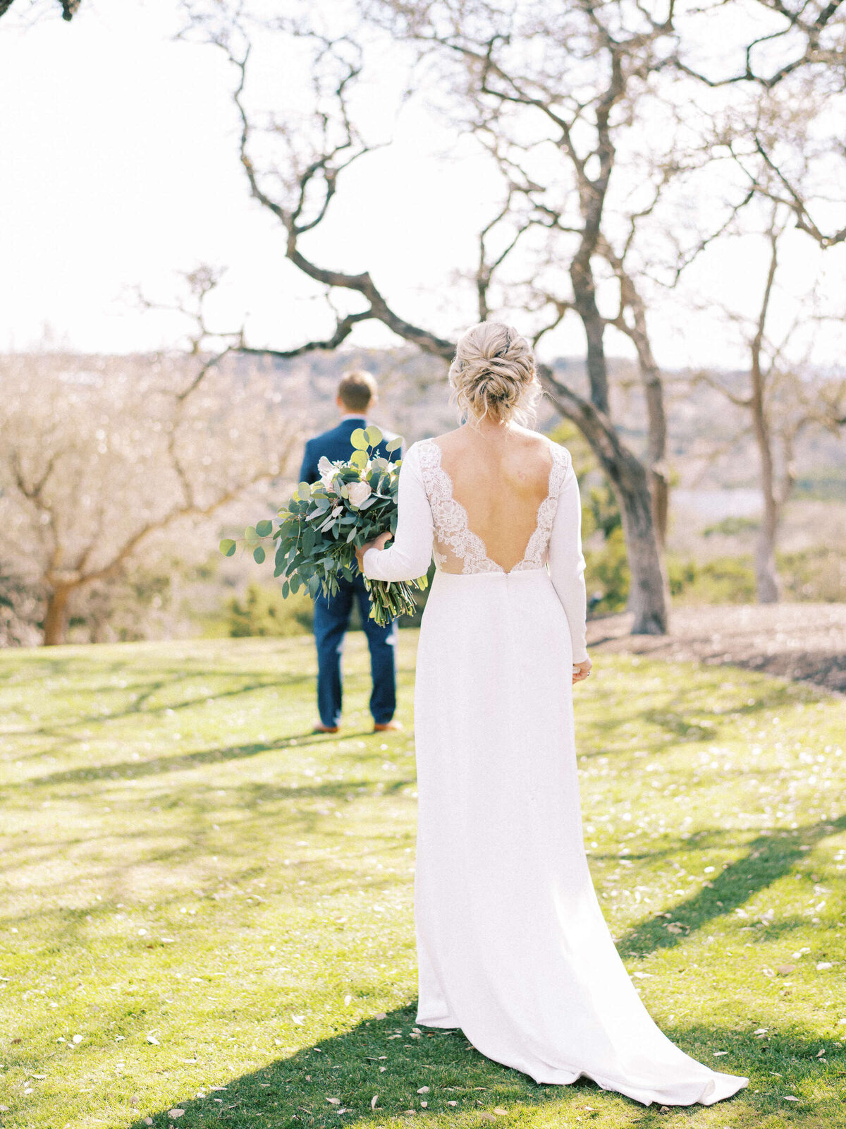 Central Texas bride walks up to her groom for the first look in Dripping Springs, Texas