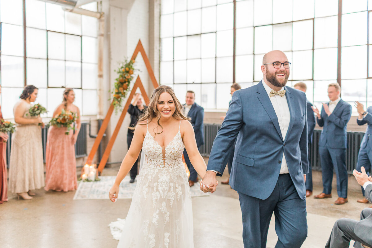 BRIDE AND GROOM HOLDING HANDS AFTER THEY ARE ANNOUNCED AS HUSBAND AND WIFE AT THE LAKE ERIE BUILDING IN CLEVELAND OHIO