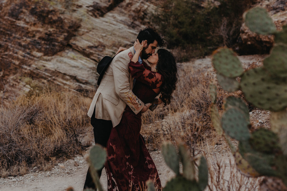 elopement dip kiss surrounded by cacti inside of Saguaro national park