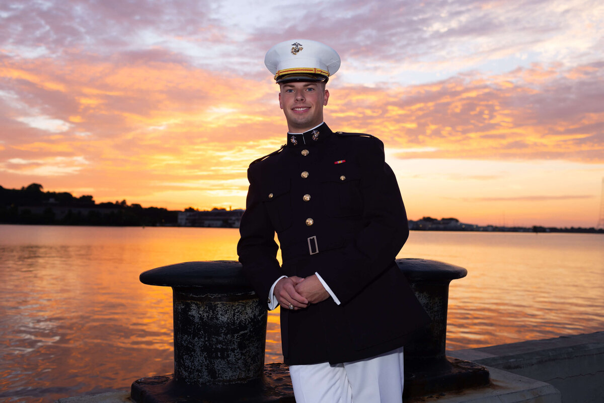 Naval Academy senior photography in Annapolis, Maryland at sunrise on the Chesapeake Bay; backlit and dramatic.