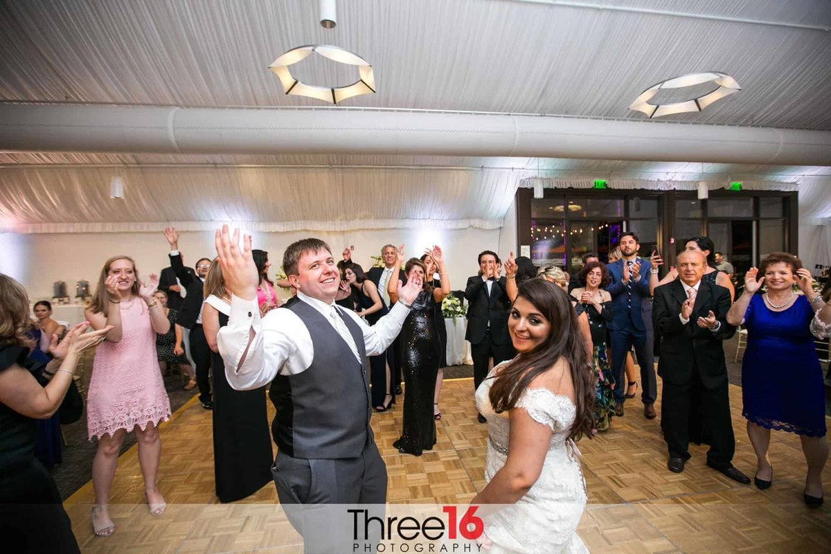 Guests surround the Bride and Groom on the dance floor
