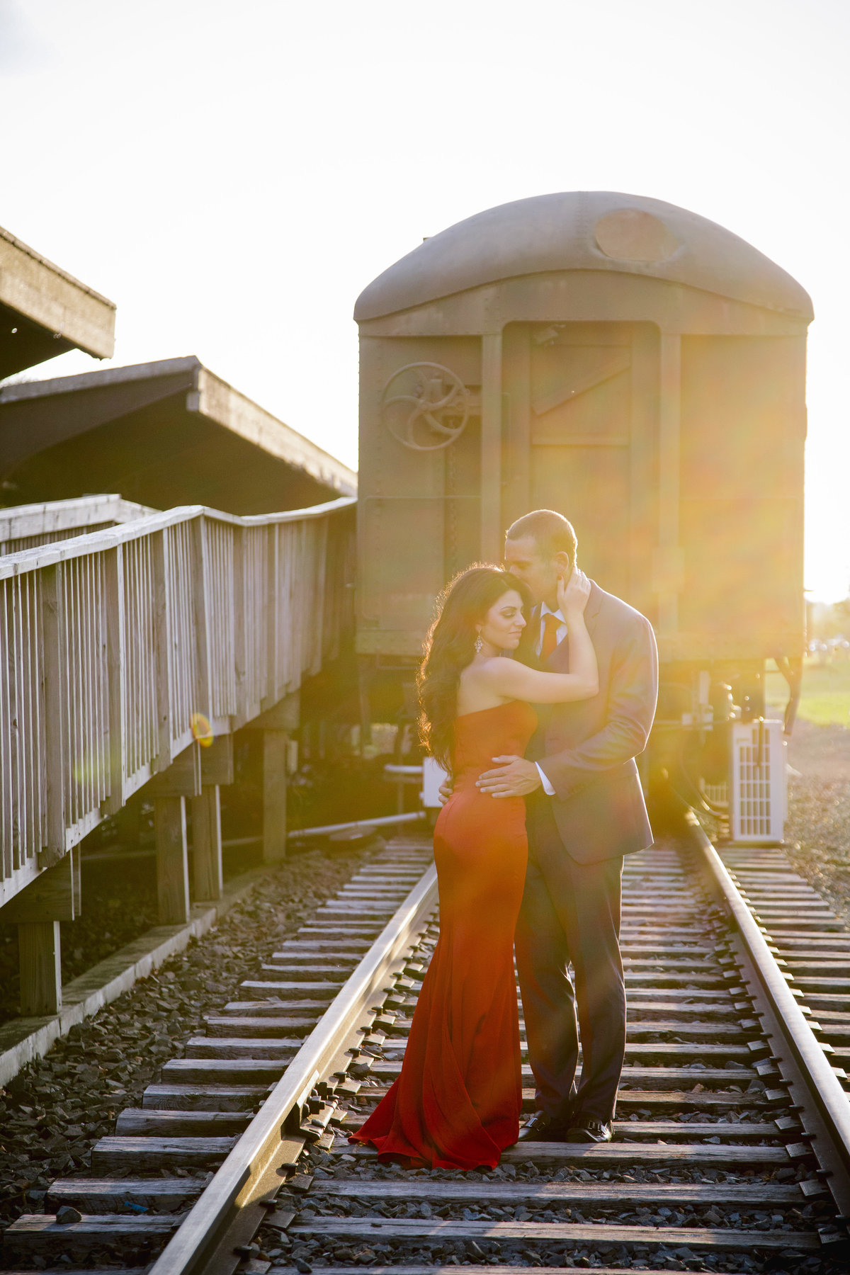 engaged couple by train at liberty state park