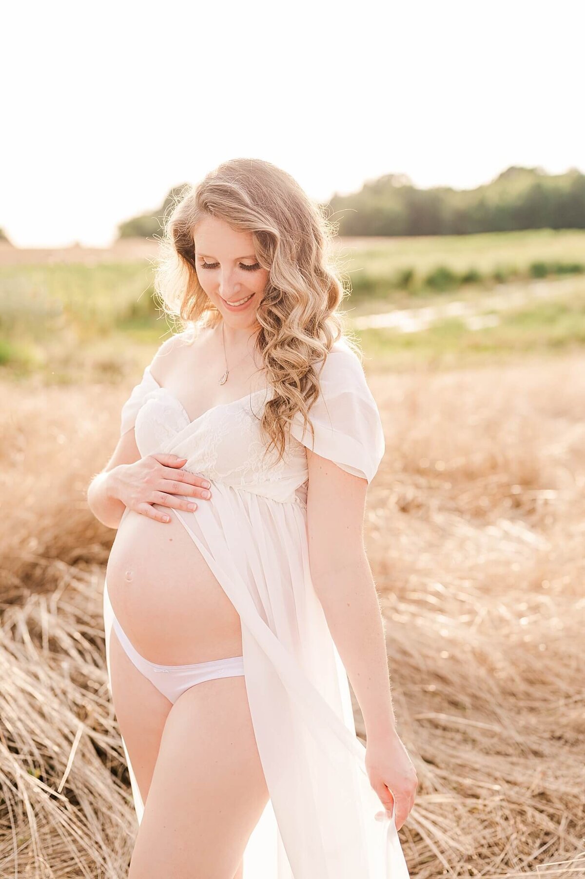 maternity session with open front gown in tall grass at howard family farms in statesville nc