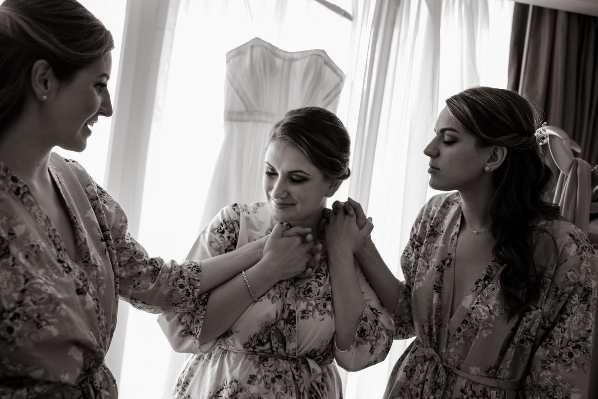 Bride and bridesmaids holding hands before wedding, Charleston Wedding Photographer