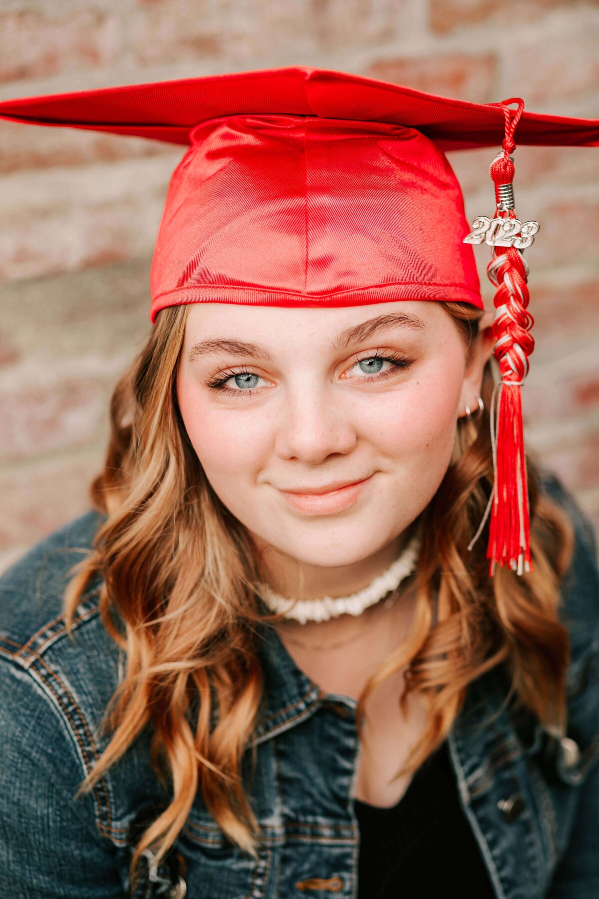South Albany High School senior graduate sits in her cap and gown downtown Albany