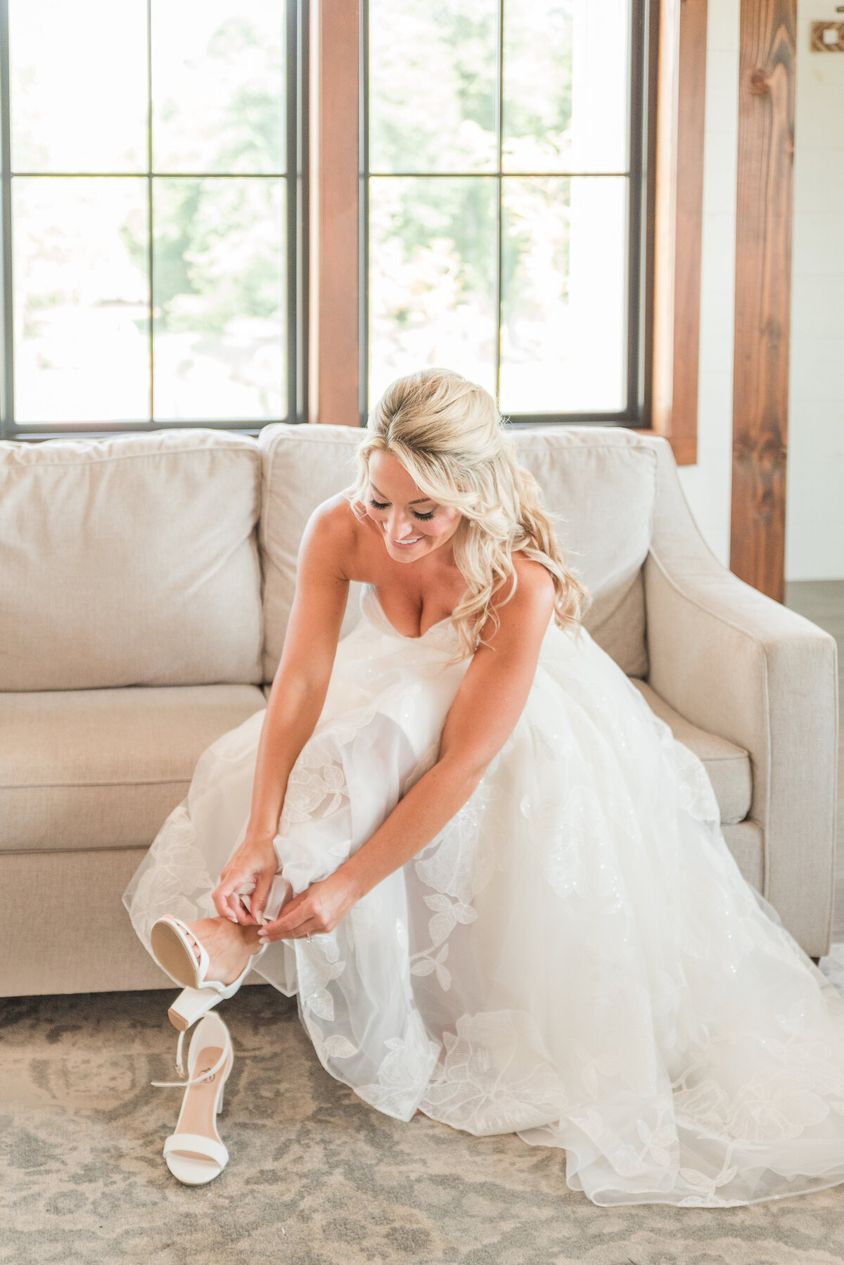 bride putting shoes on her wedding day