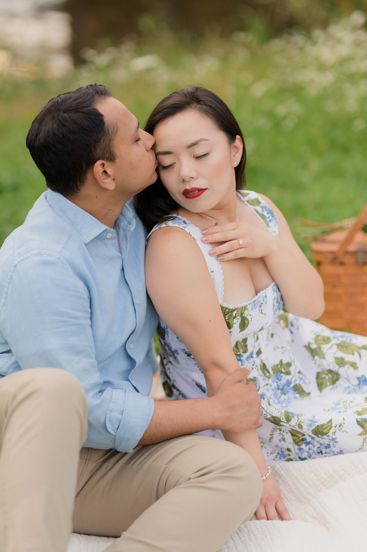 multicultural couple engagement session and a picnic at the park in new england. indain man and asian women eat ice cream and playful portraits.