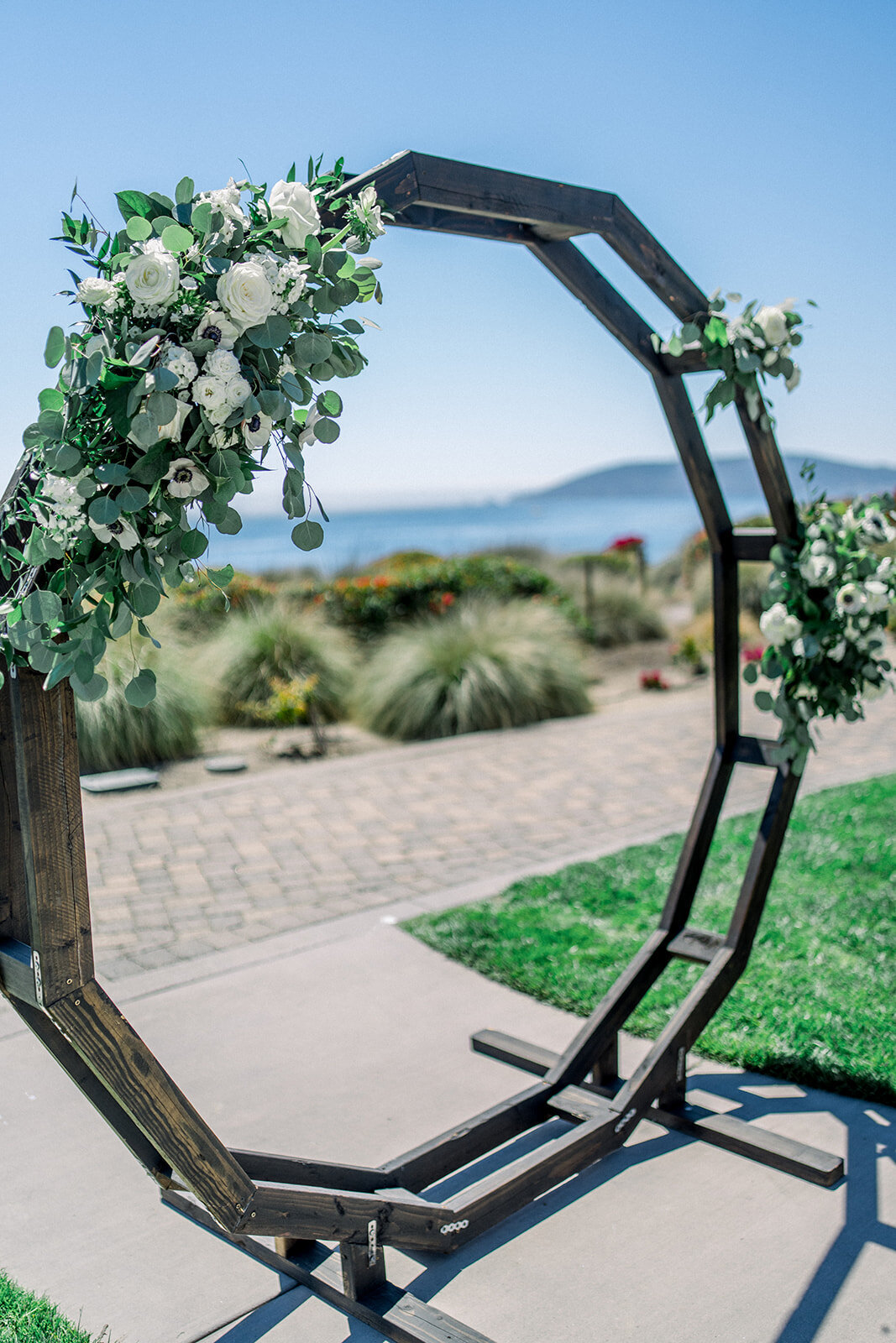 Wedding ceremony arch at Dolphin Bay Resort in Pismo Beach, CA