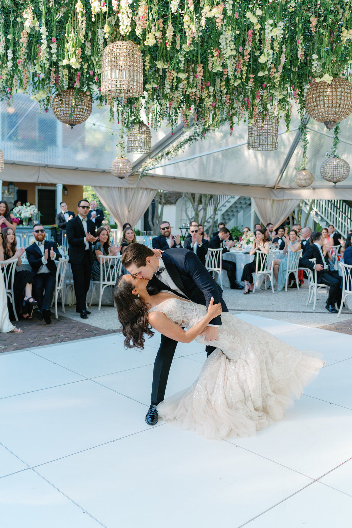 First dance on all white dance floor with hanging flowers. Spring wedding at Thomas Bennett House.  Destination wedding photographer.
