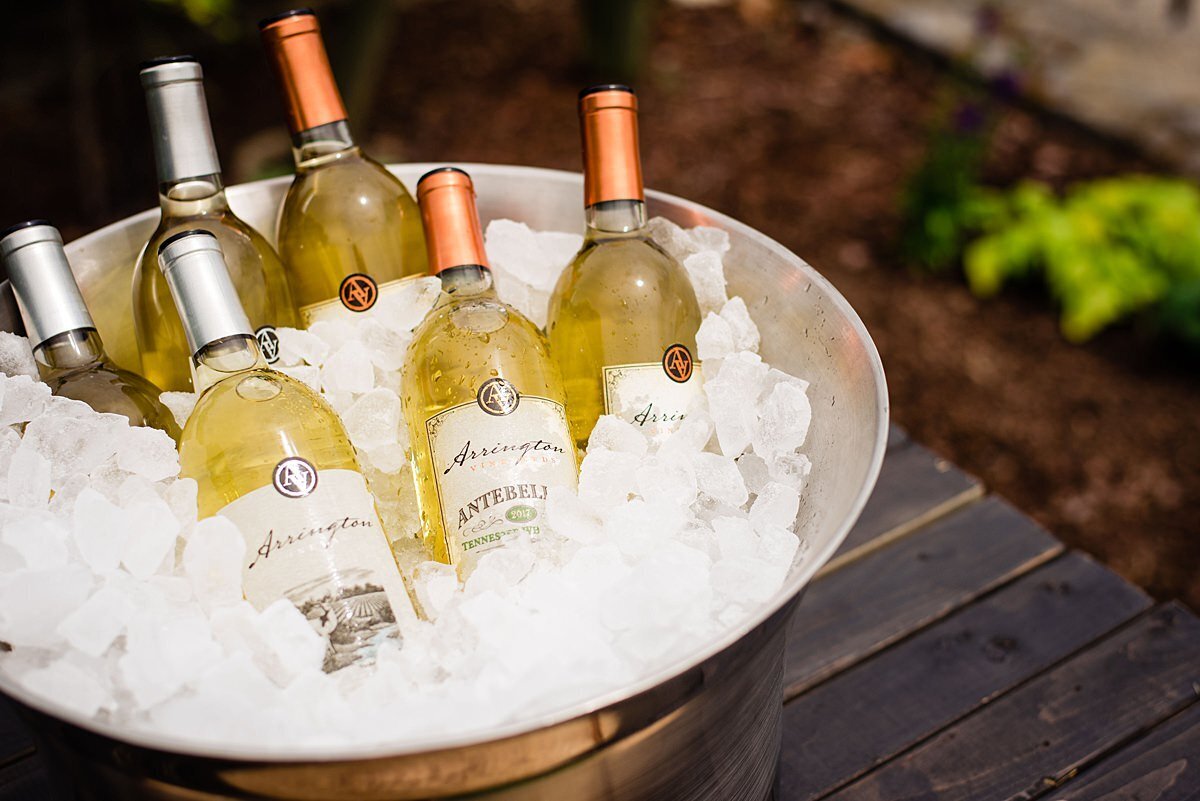 Arrington Vineyards Stags White and Arrington Vineyards Antebellum White wine in a large silver bucket of ice sitting on a farm table at Arrington Vineyards.