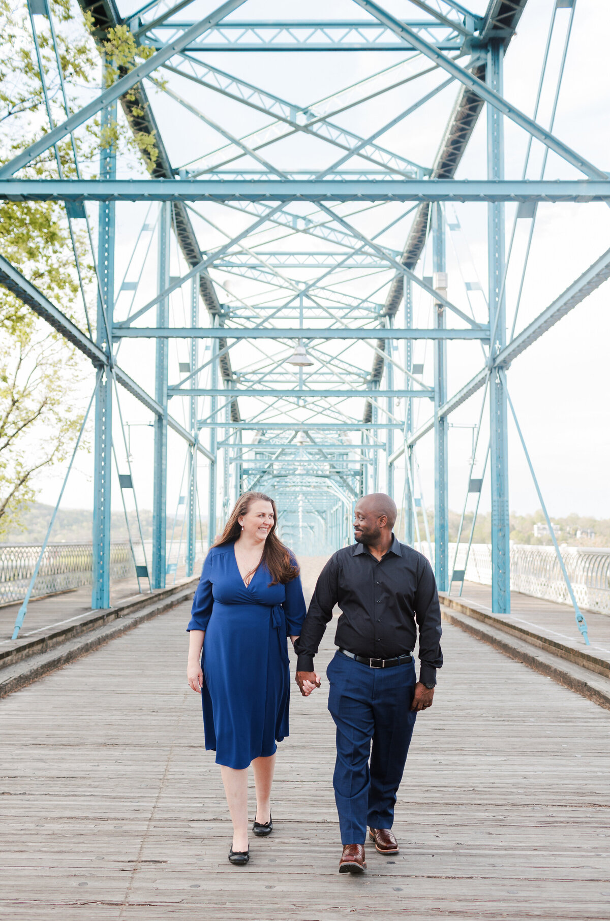 couple walking together on a bridge in Chattanooga