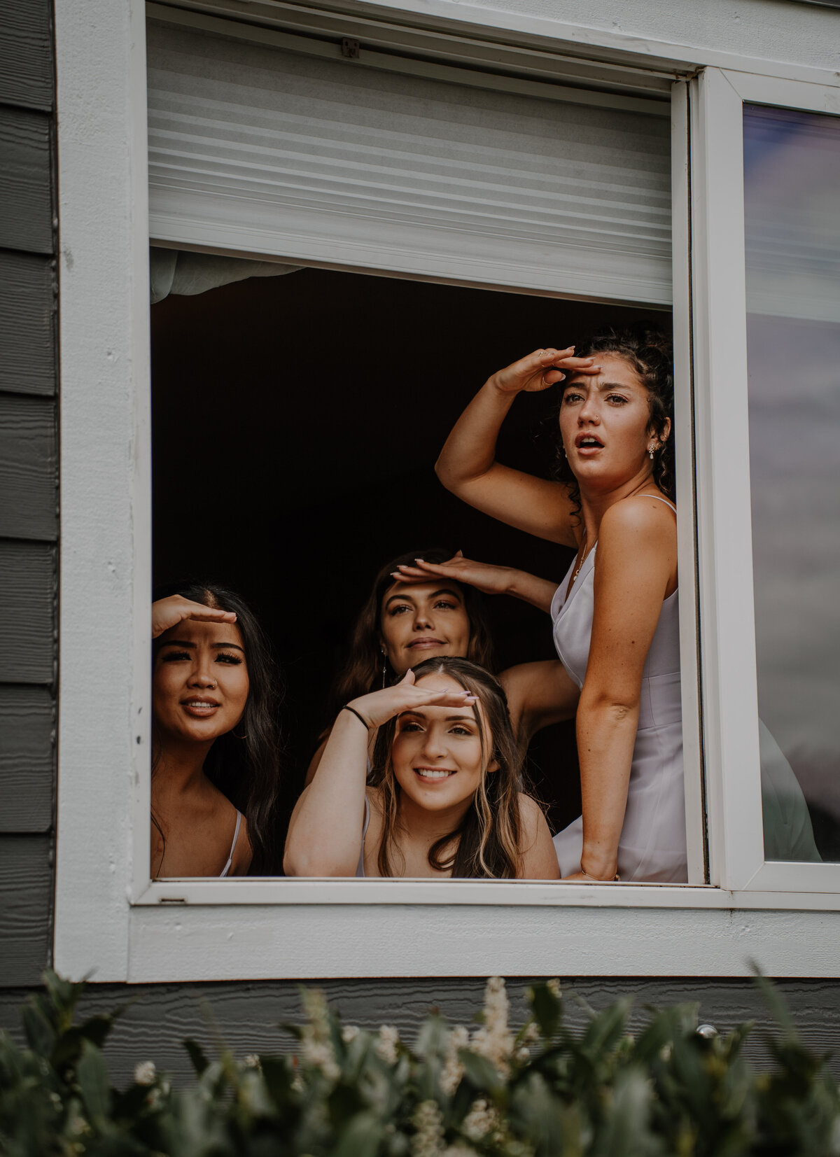 Several girls looking out window
