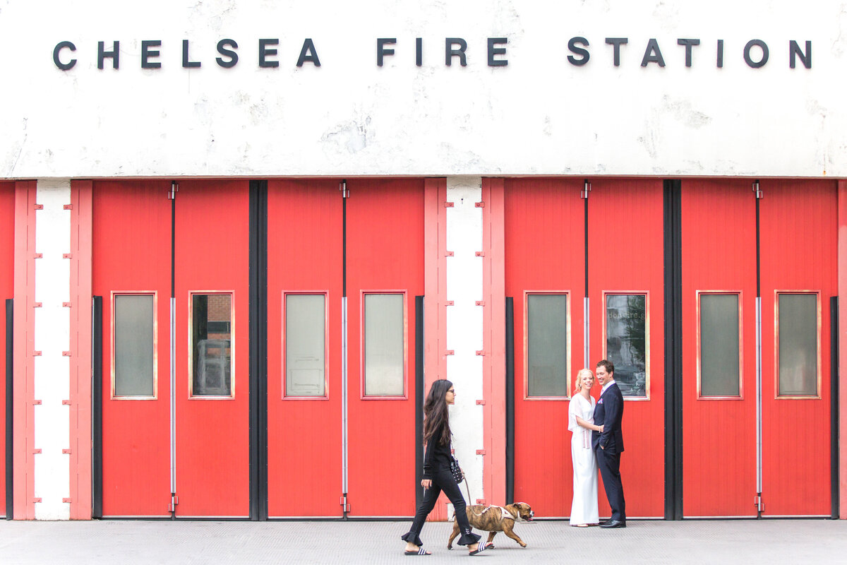 Bride and groom in front of chelsea fire station