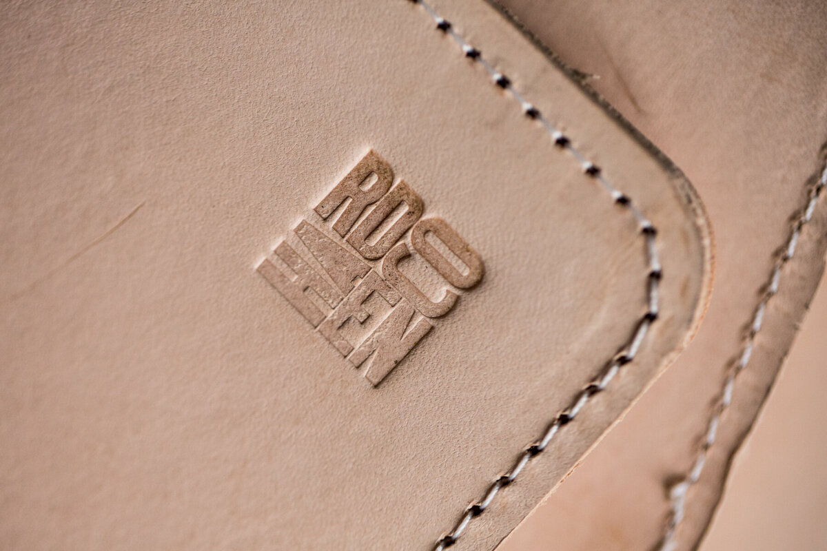 detail image of branded name in leather