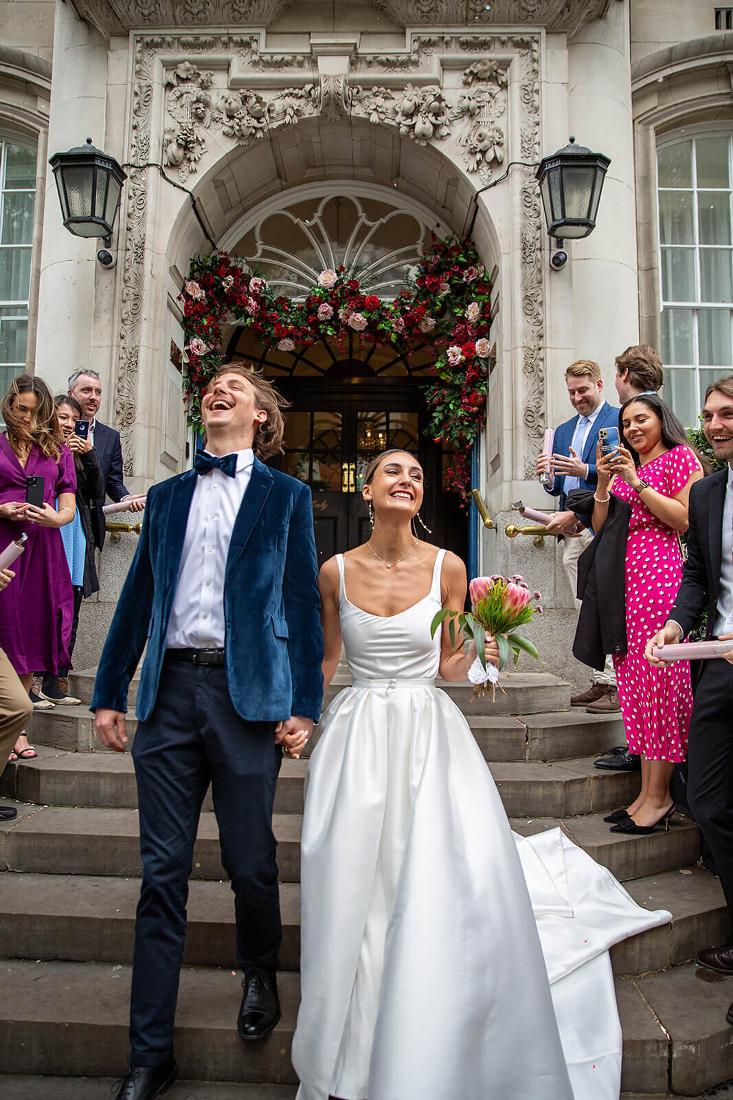 Bride and groom walking down steps of Chelsea Registry Office London