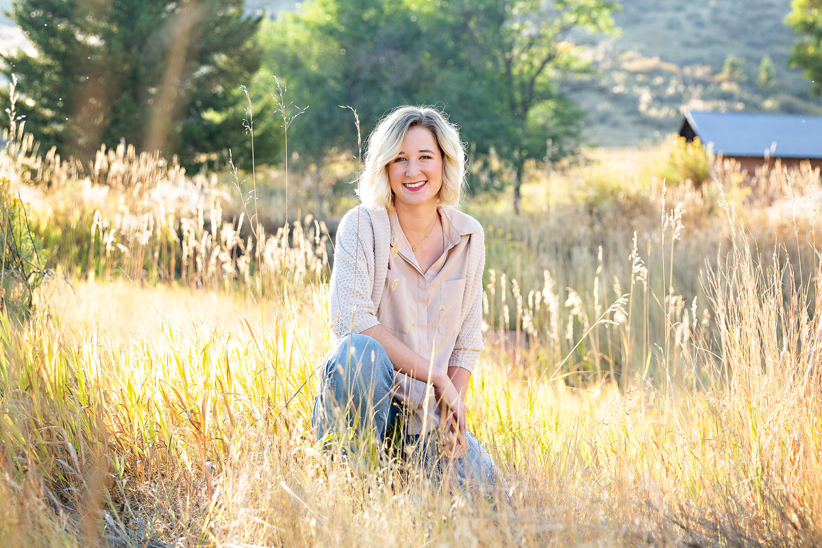 Beautifully lit outdoor senior photo session in the tall grass
