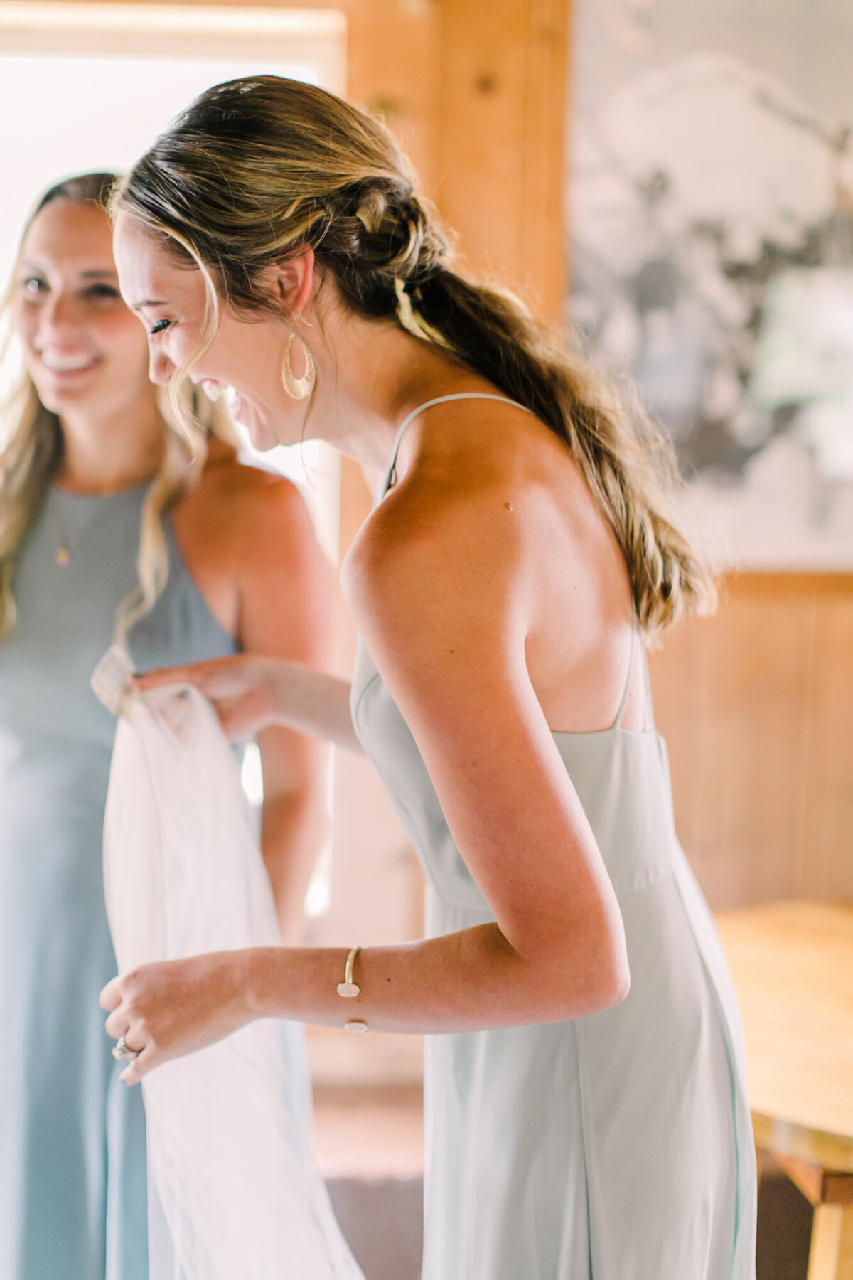 A candid moment between sisters on a wedding day