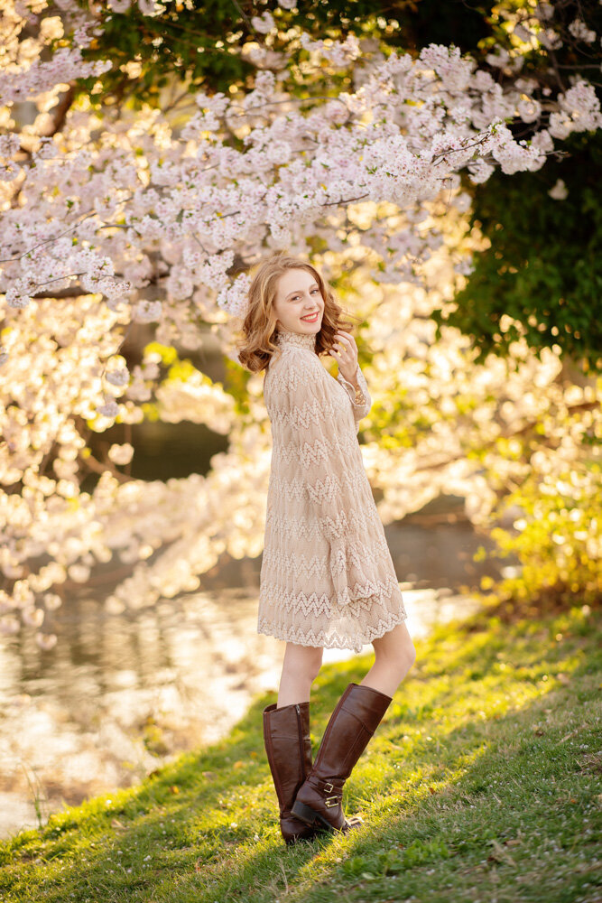 Senior session of young woman in a dress and boots