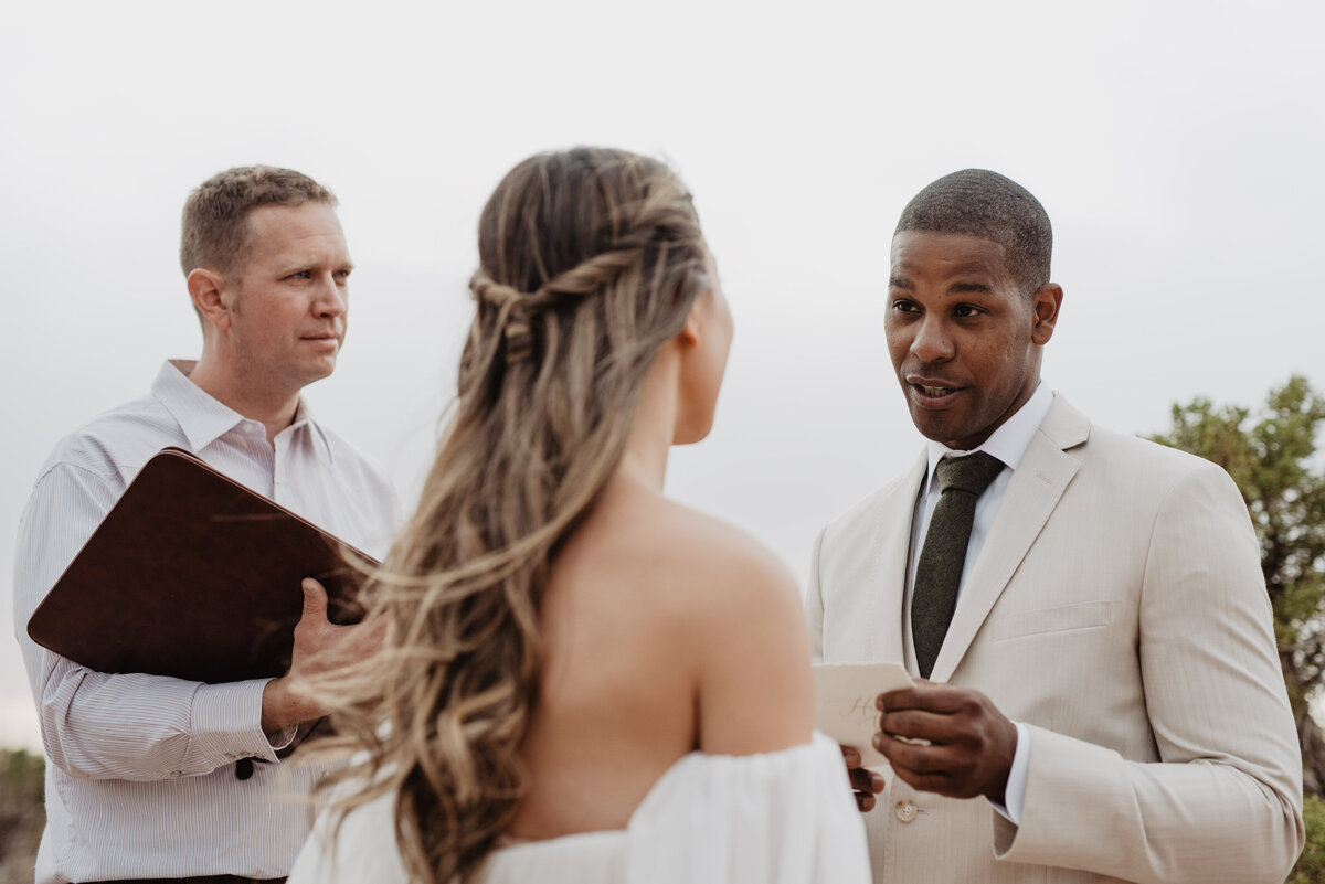 Utah Elopement Photographer captures groom reading vows