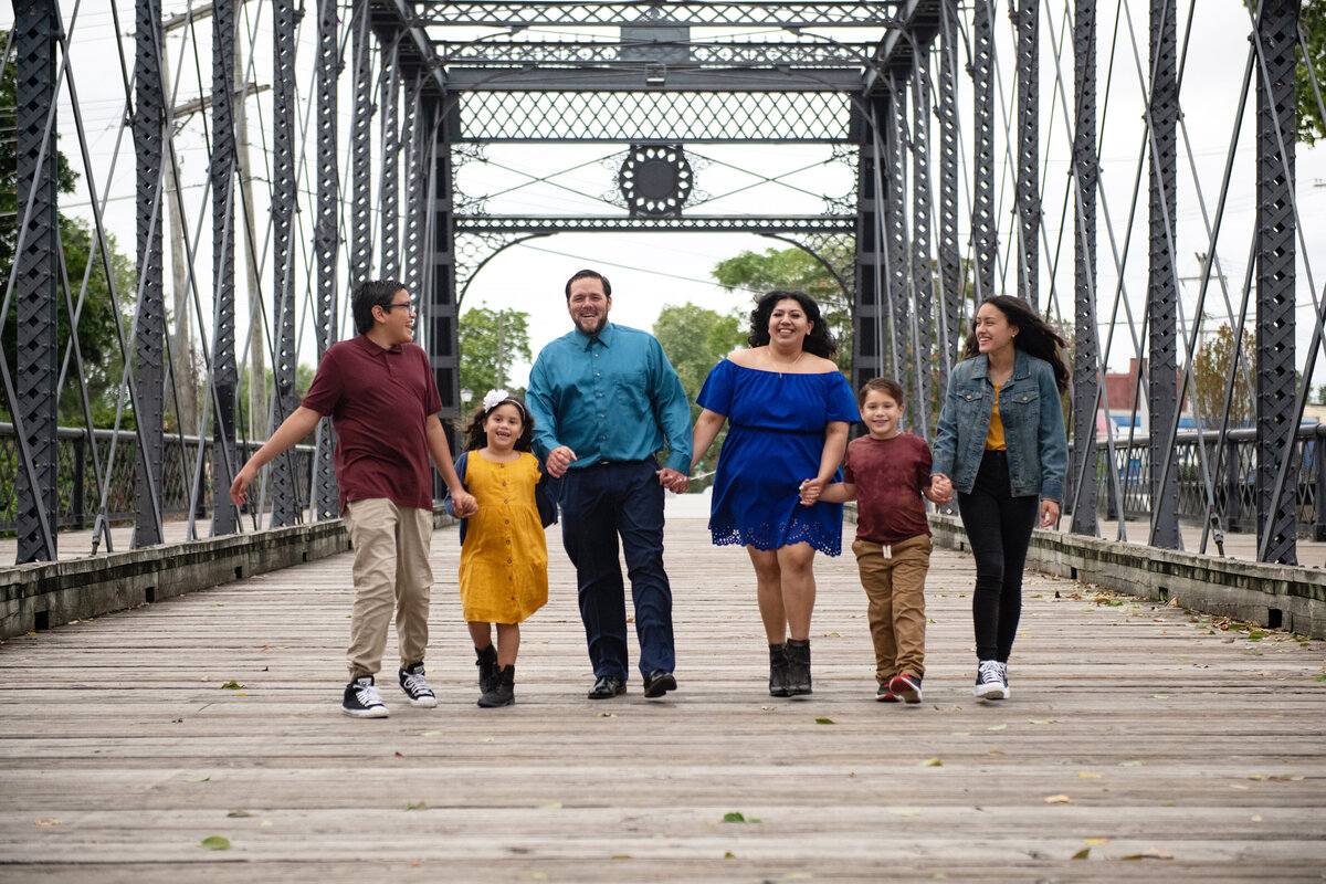 Candid portrait of family walking on bridge