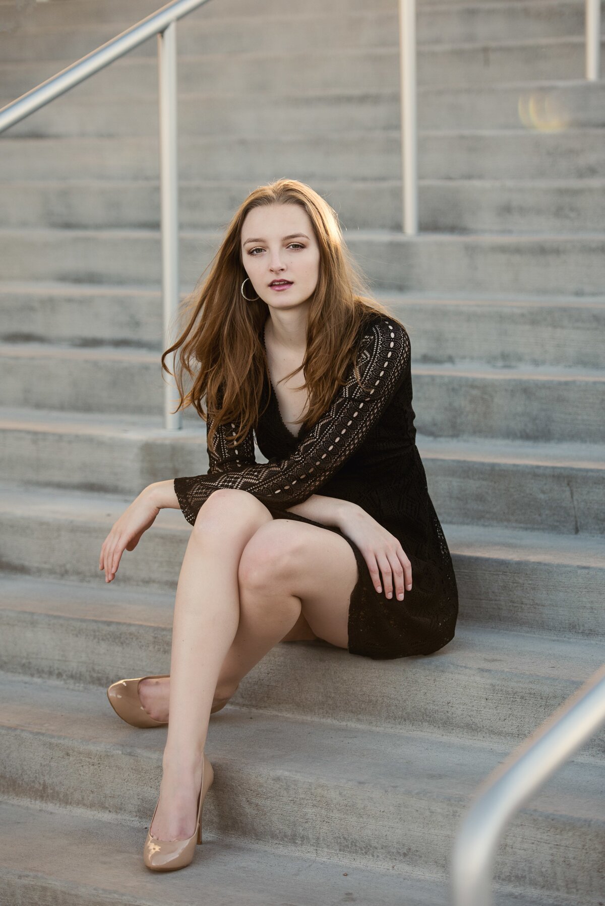Eden Prairie Minnesota high school grad photo of girl in black dress sitting on stairs in the city