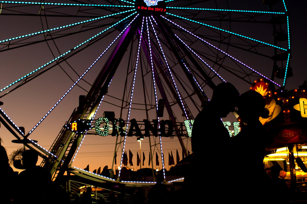 Silhouette engagement photo at Los Angeles State Fair, State Fair engagement photo at night by Faria Munmun