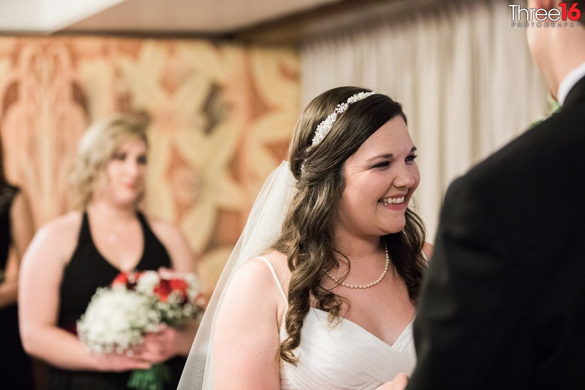 Bride smiles big during her wedding ceremony