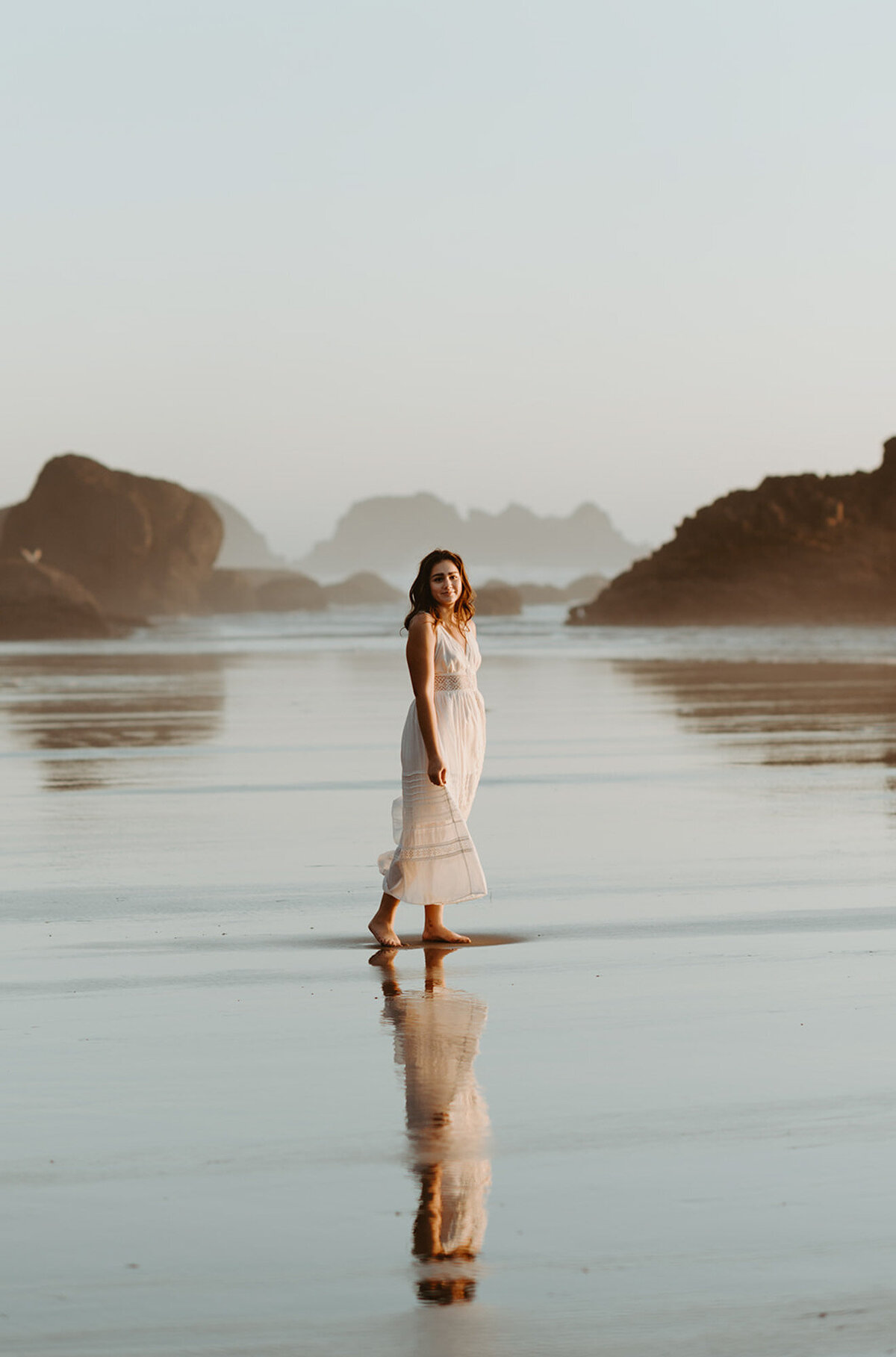 girl walking on beach in white dress