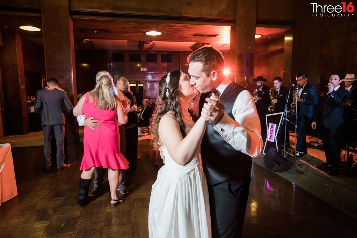 Bride and Groom share a kiss on the dance floor