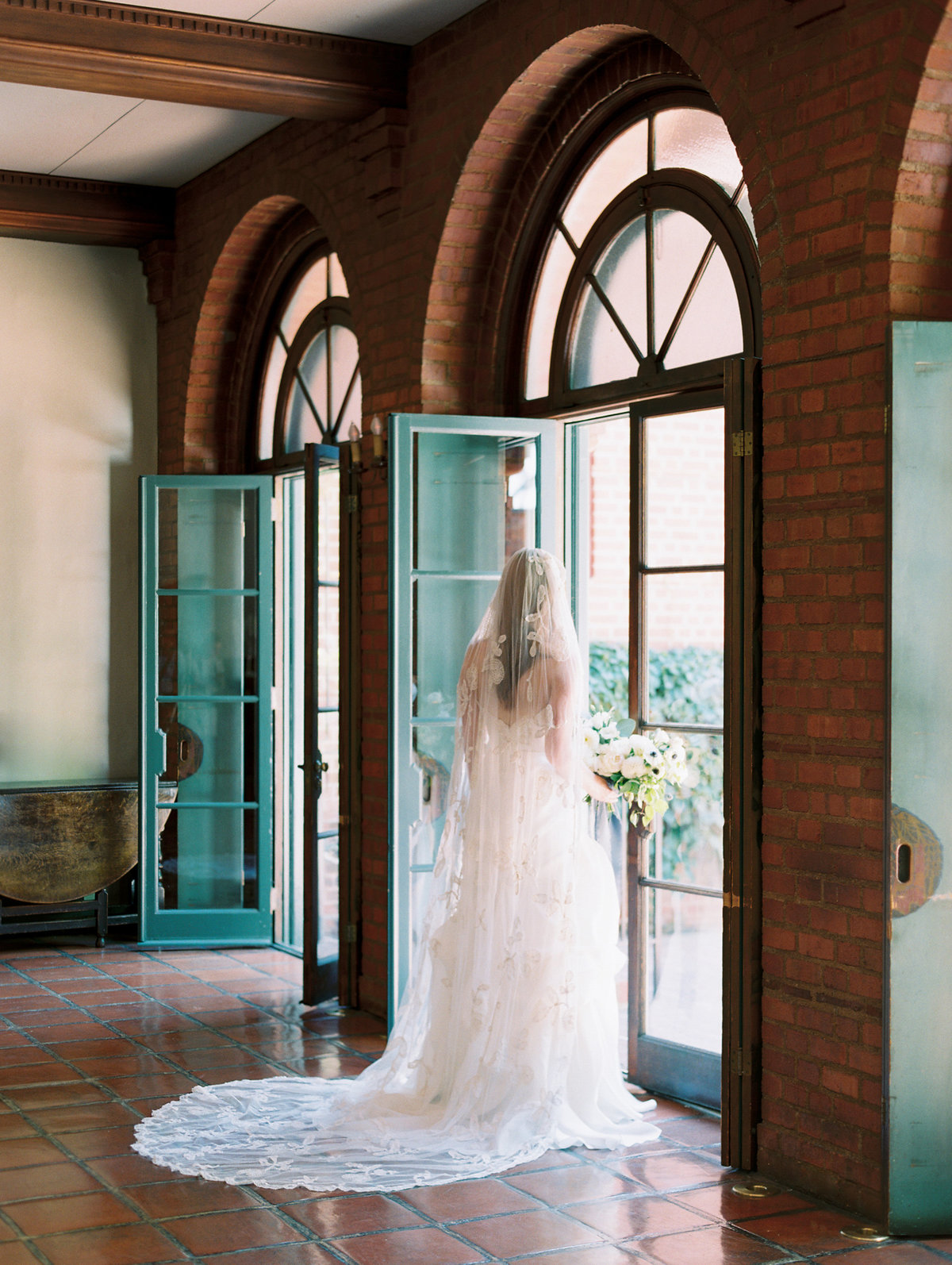 film wedding photo of a bride standing in a doorway
