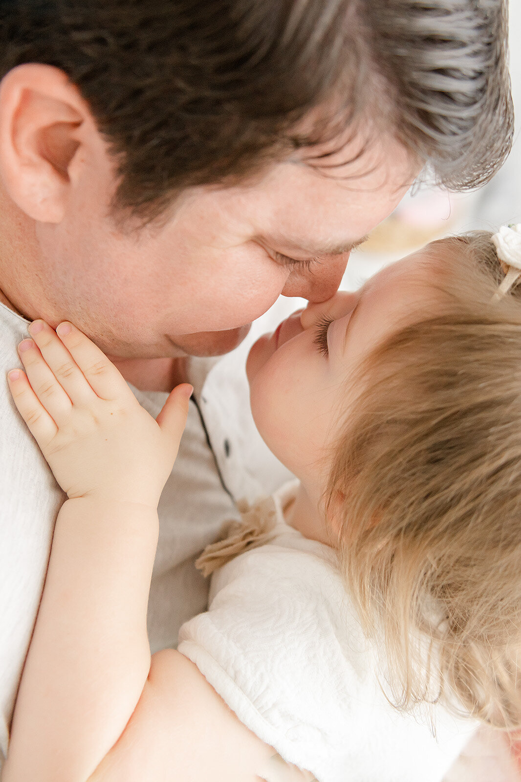 eskimo kiss between father and daughter