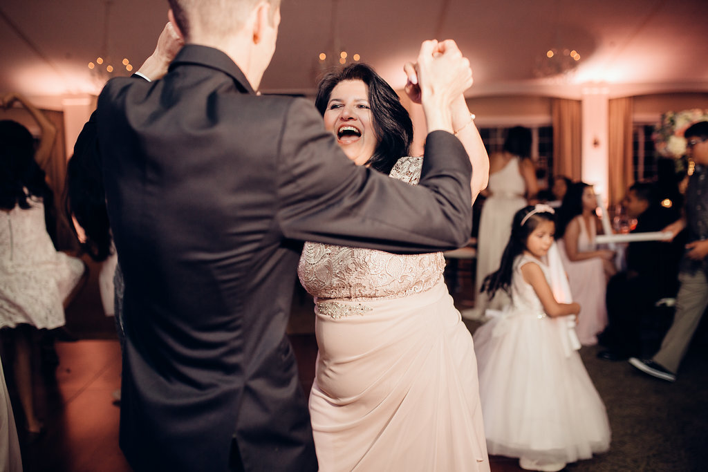 Wedding Photograph Of Woman Laughing While Dancing With The Groom Los Angeles