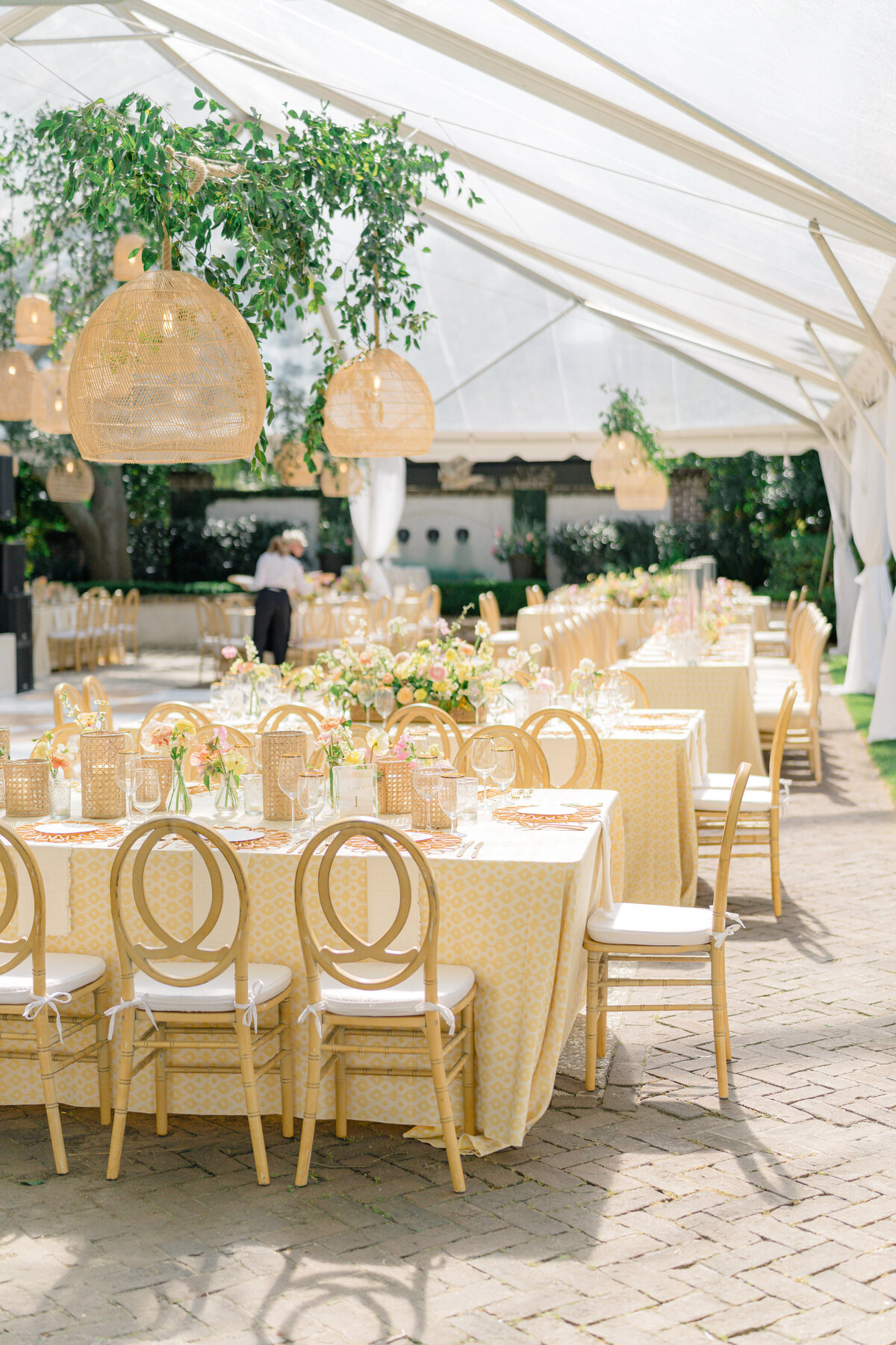 Pink and yellow wedding reception design with hanging greenery and lighting. Charleston spring wedding design.