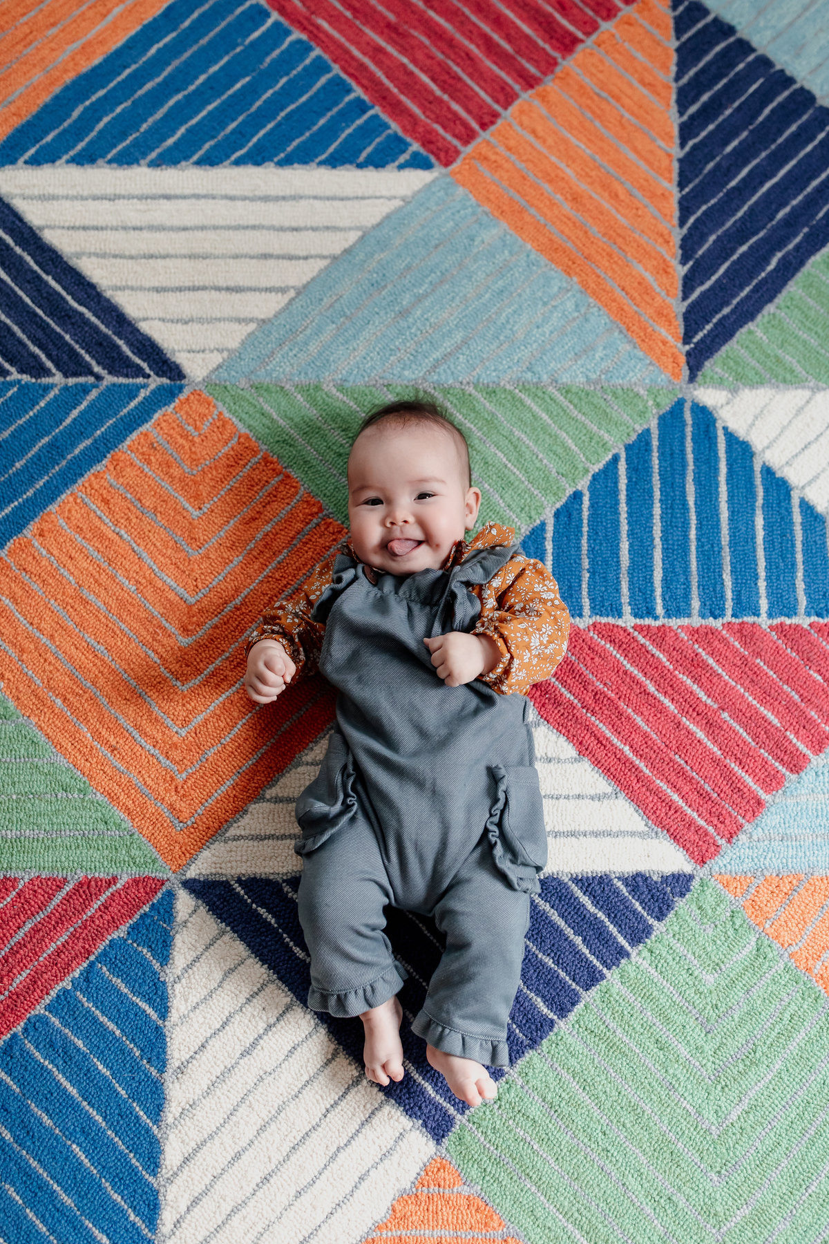 San Francisco baby portrait with colorful geometric rug as backdrop