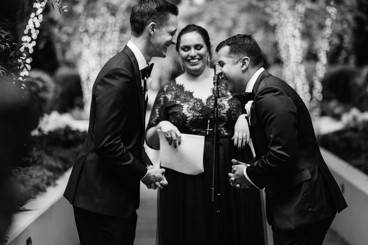 Grooms with officiant, black and white