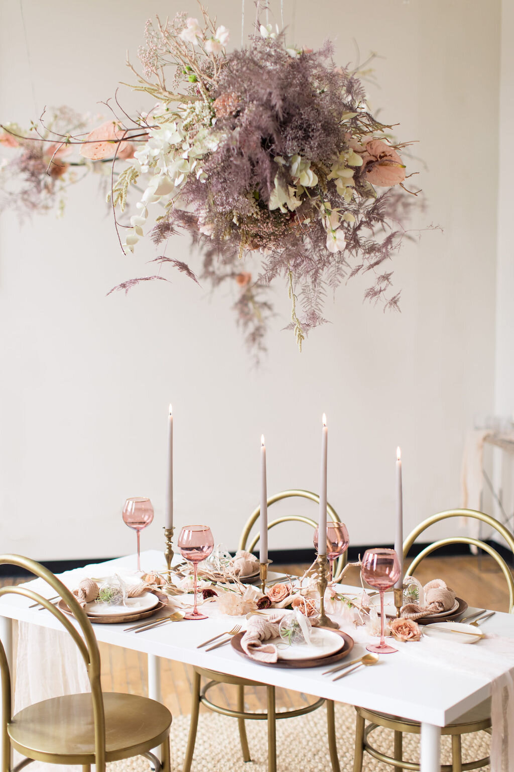 Modern indoor wedding reception with hanging floral arrangement