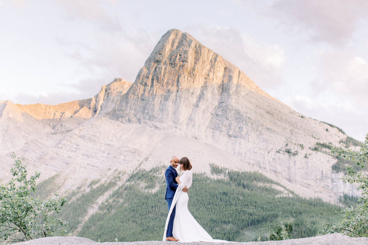 Wide shots of a mountain range with the bride and groom  close together