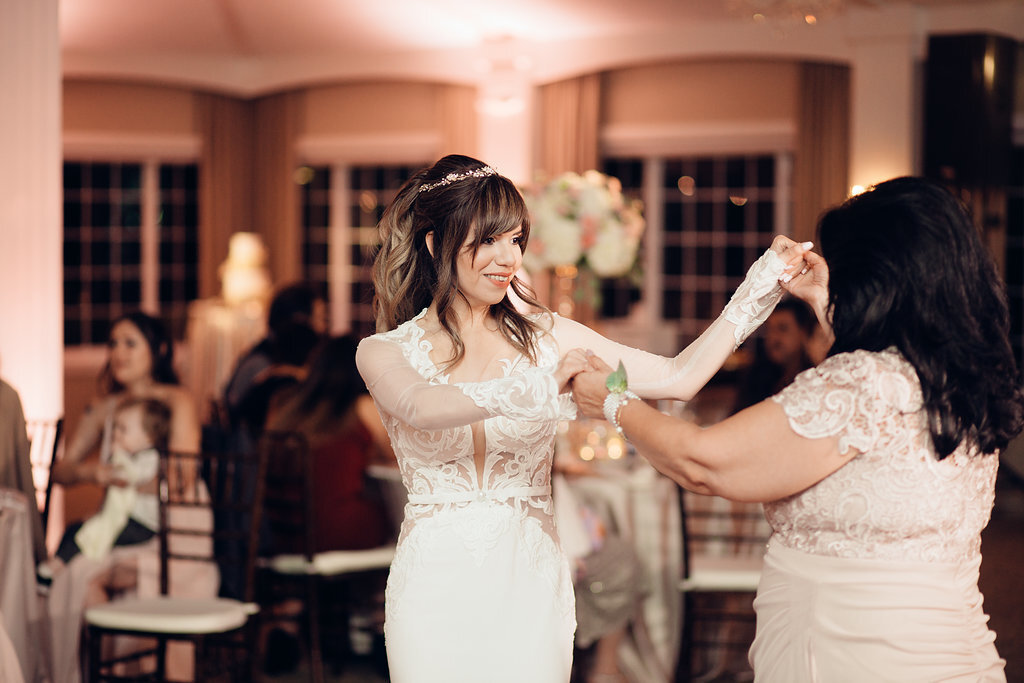 Wedding Photograph Of Bride In White Dress Dancing With A Woman In Light Brown Dress Los Angeles
