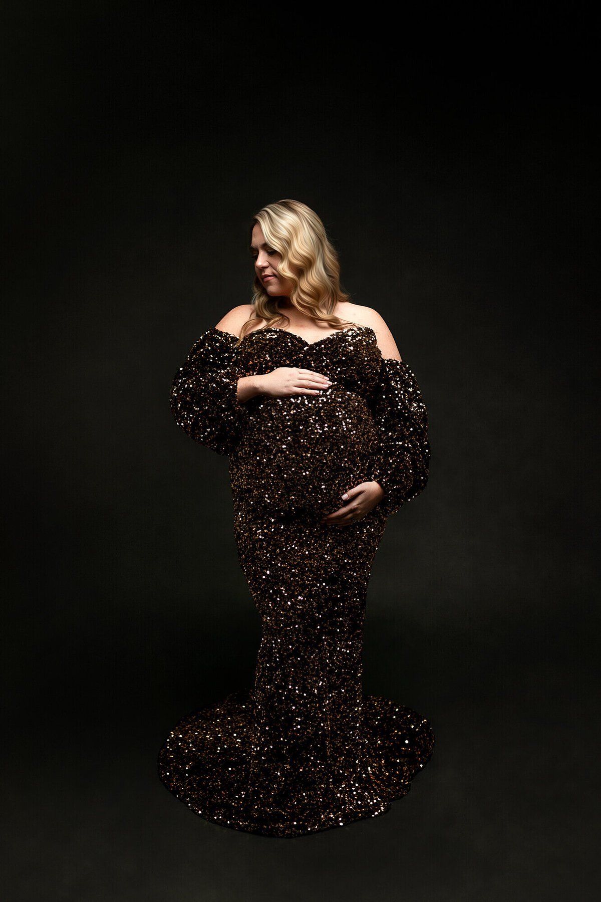 Stunning mother wearing a gold and black gown.